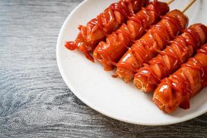 fried sausage skewer with ketchup photo