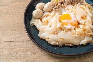 dried spicy noodles with minced pork, meatballs and egg photo