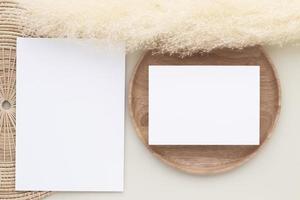 Blank paper cards, Mockup with pampas grass on a wooden plate, beige background, Minimal beige workplace composition, flat lay, mockup photo