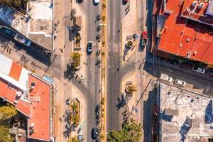 Aerial view of the street intersection with cars driving down the road. photo
