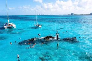 People snorkelling around the ship wreck near Bahamas in the Caribbean sea. photo