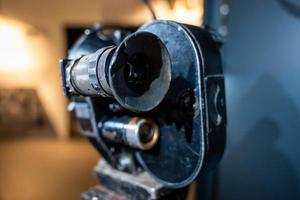 Close up photo of old vintage camera lens over wooden table.