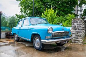 Close-up view of the old russian car GAZ-21 Volga parked in the yard. photo