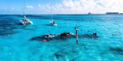 People snorkelling around the ship wreck near Bahamas in the Caribbean sea. photo