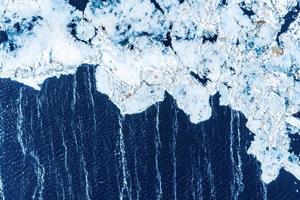 Big chunks of ice blocks forming a beautiful pattern, after the icebreaker ship passed by and crushed the densely packed ice. photo