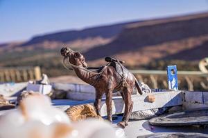 Small camel figure display on table for sale in sunny weather photo