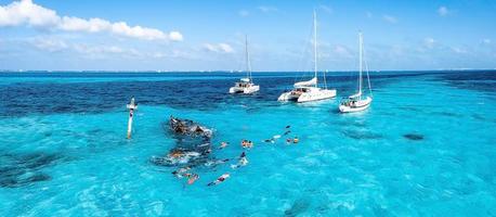 People snorkelling around the ship wreck near Bahamas in the Caribbean sea. photo