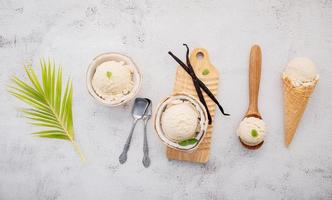 Coconut ice cream flavours in half of coconut setup on white stone background. Summer and Sweet menu concept. photo