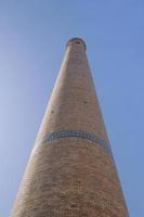 The view from the bottom up. High tower quite ancient Asian buildings. the details of the architecture of medieval Central Asia photo