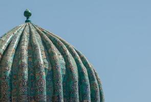 Part of the roof of the dome with tile in ancient Asian style. the details of the architecture of medieval Central Asia photo