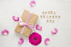 happy mothers day inscription with gift box gerbera photo