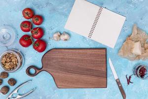 healthy ingredient kitchen utensil with open blank diary blue textured backdrop photo