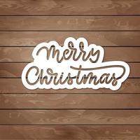 Merry christmas hand lettering inscription on wood texture for winter holiday design. vector