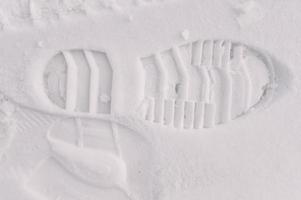 Huella de arranque textura de la banda de rodadura del zapato en la nieve foto