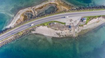 Aerial photo of roads on small island with cars driving