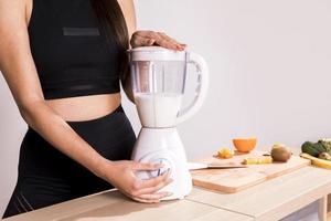 fitness woman preparing detox juice photo