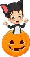 Cartoon little boy wearing halloween cat costume inside pumpkin