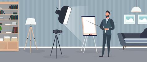 A man in a business suit with a tie is giving a presentation to the camera. The teacher is writing a lesson. The concept of blogging, online training and conferences. Camera on a tripod, softbox. vector