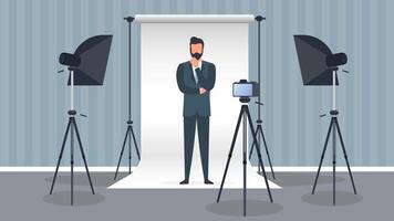 Photo Studio Vector. A man in a business suit poses for the camera. White canvas background on tripods. Camera on a tripod, softbox. Professional photo studio. vector