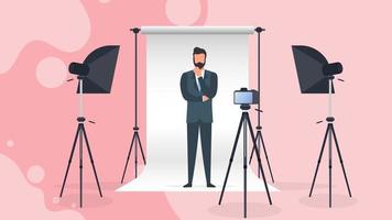 Photo Studio Vector. A man in a business suit poses for the camera. White canvas background on tripods. Camera on a tripod, softbox. Professional photo studio. vector