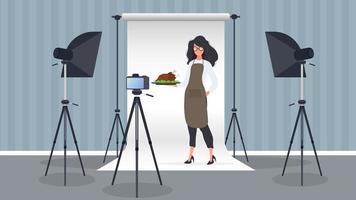 Woman cook in the kitchen keeps leading a culinary vlog. A girl in a kitchen apron holds a fried chicken. Vector. vector