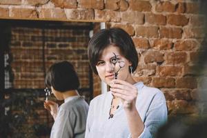 Young beautiful hairdresser woman with scissors in hand in the barbashop salon. Barbershop advertising concept. Place for text or advertising photo