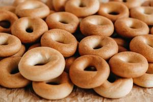 Drying or mini round bagels on kraft paper background. Copy, empty space for text photo