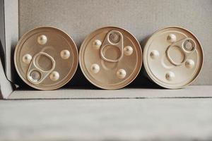 Metal closed canned food on a cardboard background photo