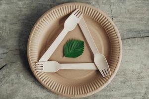 Wooden forks and plate on wooden background photo