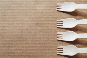 Wooden forks on a cardboard background photo