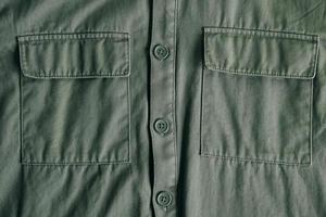 Two closed pockets and buttons on a winter green jacket. Top view. Copy, empty space for text photo