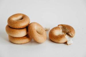 Drying or mini round bagels on a white wooden background. Copy, empty space for text photo