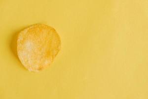 Potato chip on a yellow background photo