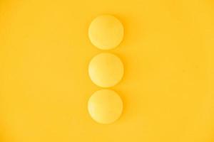 Yellow balls on yellow background. Minimal concept. Top view. Copy, empty space for text photo