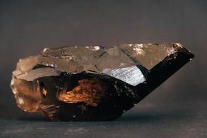 Smoky quartz crystal on black background photo