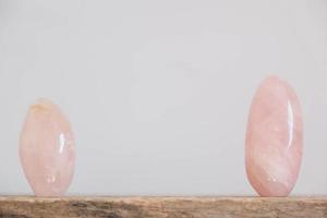 Polished crystals rose quartz gemstone on a wooden table photo