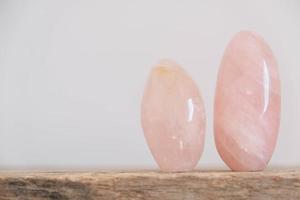 Polished crystals rose quartz gemstone on a wooden table
