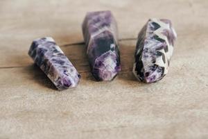 Amethyst polished crystal point on a wooden table photo