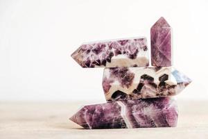 Amethyst polished crystal point on a wooden table photo