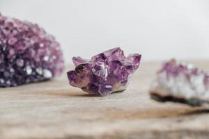 Violet amethyst crystal on wooden background photo