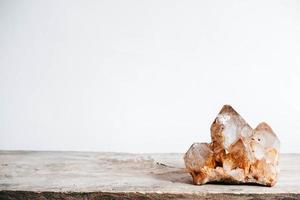 Smoky quartz crystal on a wooden surface on a white background. Copy, empty space for text photo