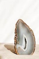 A polished agate mineral on a wooden table. photo