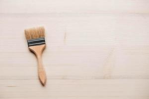 Paint brushes with a wooden handle and natural bristles on a wooden background photo