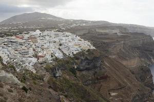 Famous view over the village of Oia at the Island Santorini, Greece photo