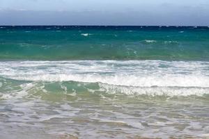 Beautiful white clouds on blue sky over calm sea with sunlight reflection, Bali Indonesia. Tranquil sea harmony of calm water surface. Sunny sky and calm blue ocean. photo