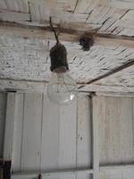 old black lamp fittings against the background of the house ceiling made of woven bamboo. dirty light fittings. photo