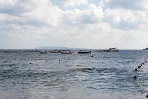 Boats in the sea on the horizon. photo