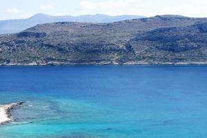 The view of the beach, the mountains and the sea. photo