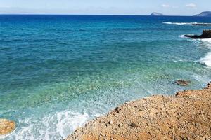 The cliff above the sea. The shoreline of the ocean from the top. photo