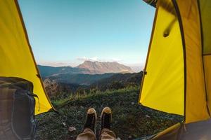 Yellow tent on the mountain and sunset view